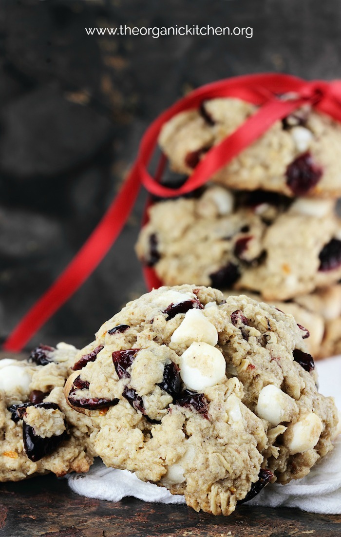 White Chocolate Cranberry Bliss Cookies tied with red ribbon with dark background