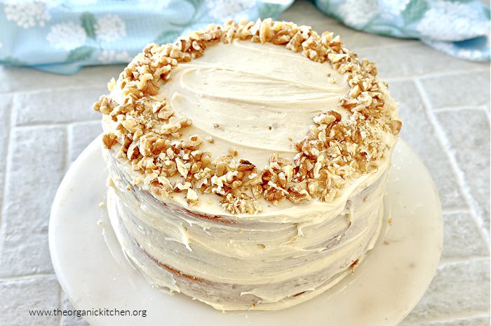 Hummingbird Cake (with gluten free option) on white plate with blue dish towel in the background