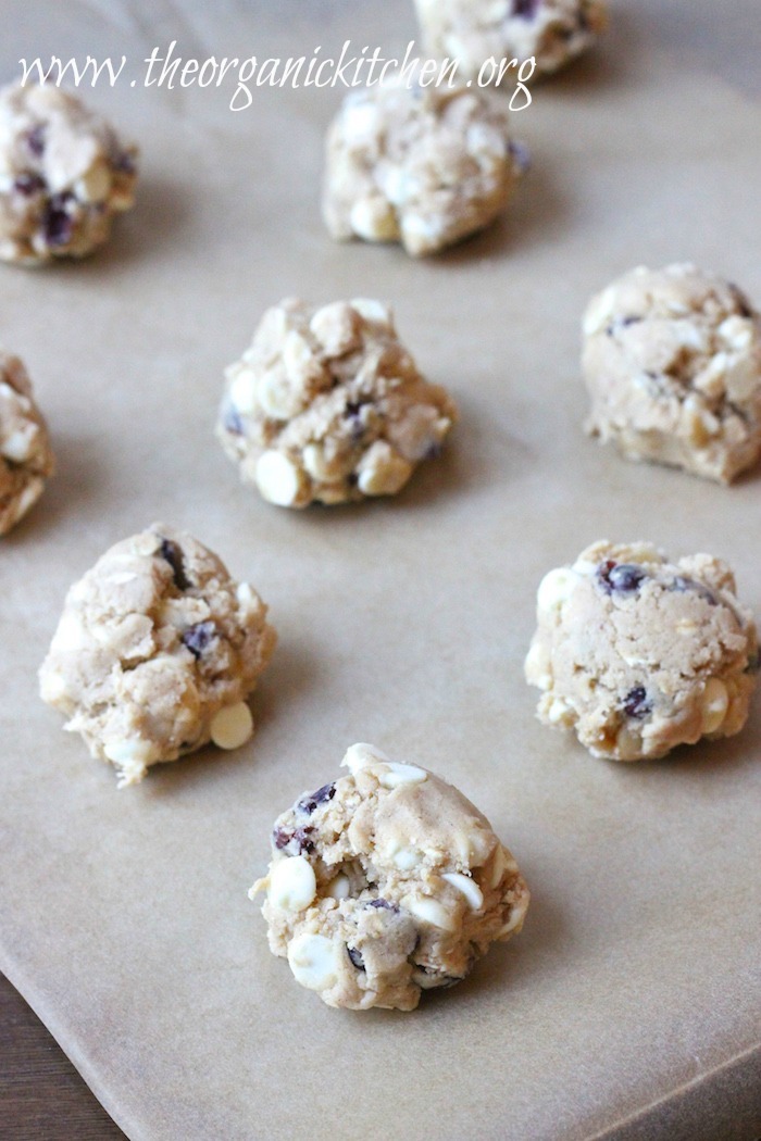 Balls of raw cookie dough on a baking sheet. White Chocolate Cranberry Bliss Cookies