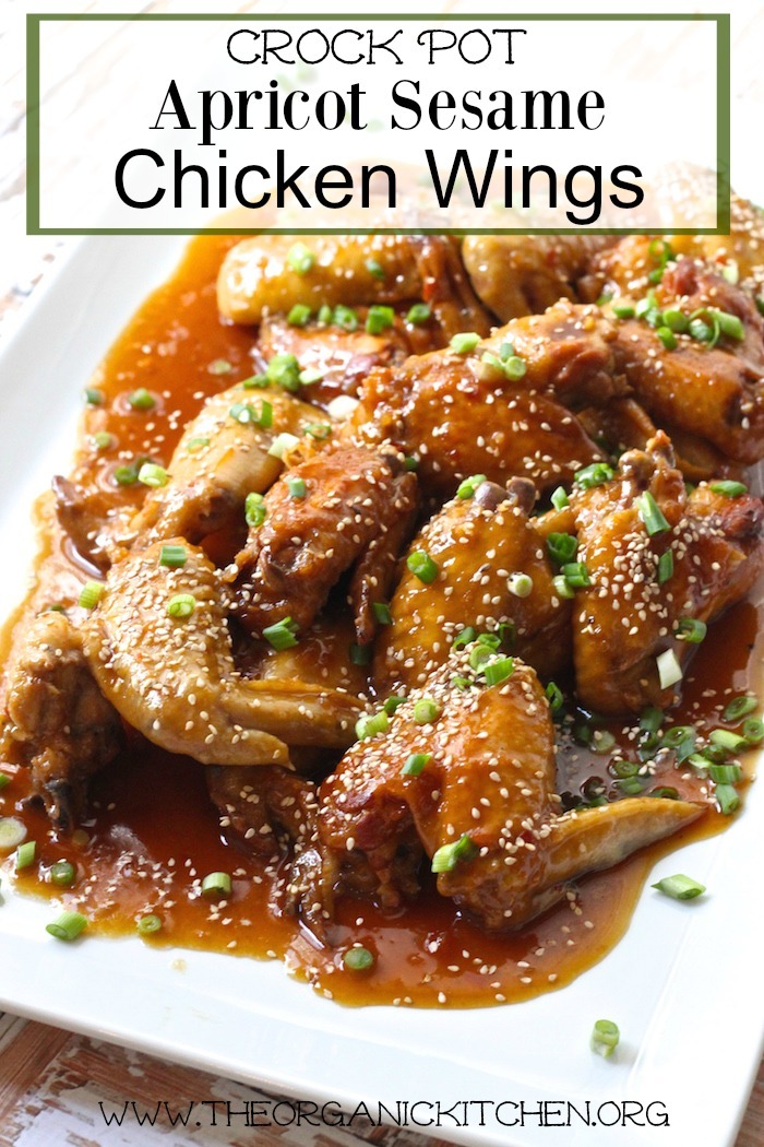 Apricot Sesame Crock Pot Chicken Wings on white platter garnished with chives and sesame seeds