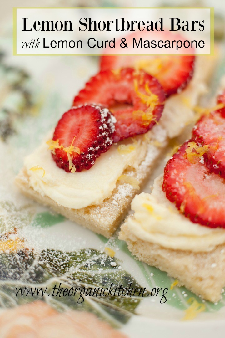 Two Lemon Shortbread Bars with Mascarpone dusted with powdered sugar on colorful plate