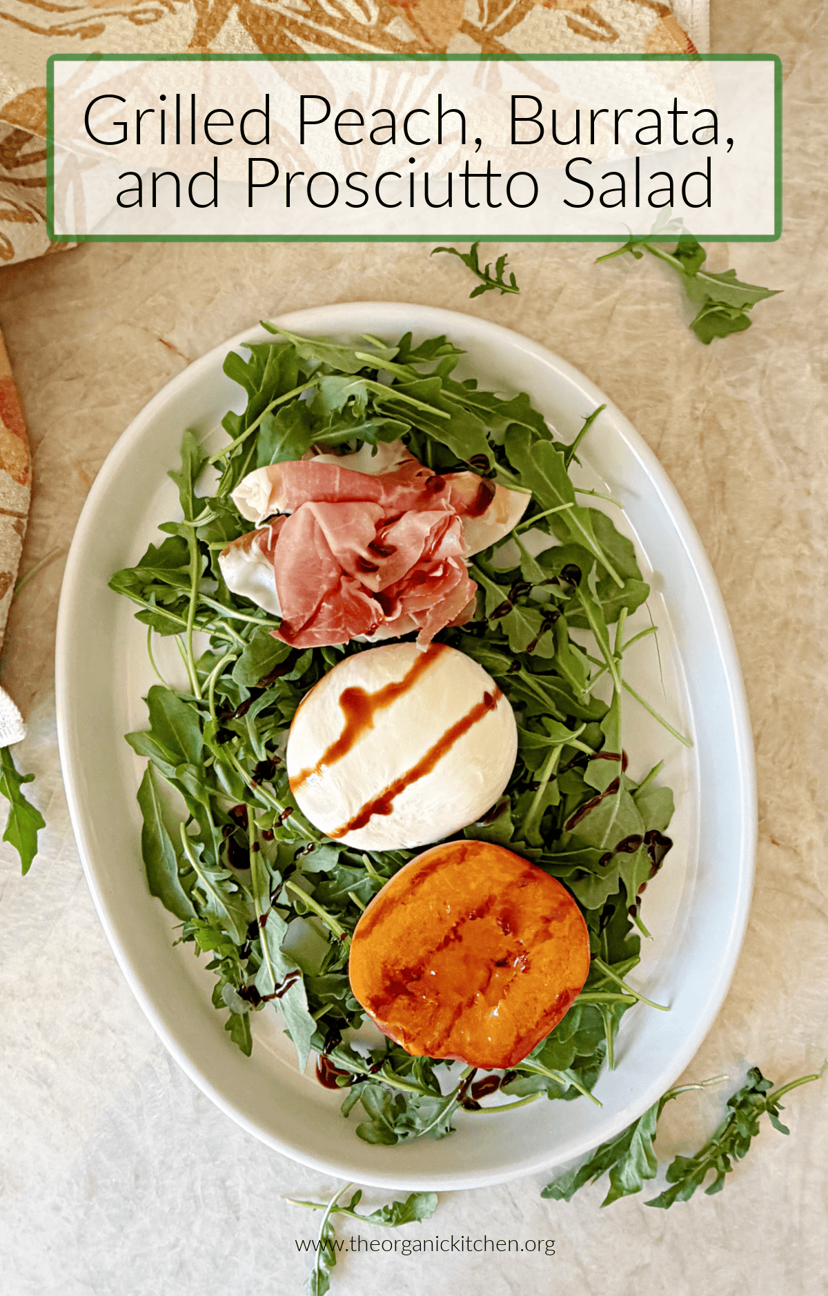 Grilled Peaches with Burrata and Prosciutto on aed of argula on a white platter