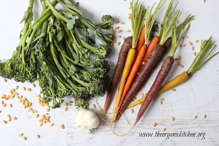 Broccolini, garlic and Rainbow Carrots on a white background