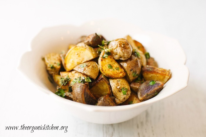 Crispy roasted Mecian potatoes with gremolata in a white bowl