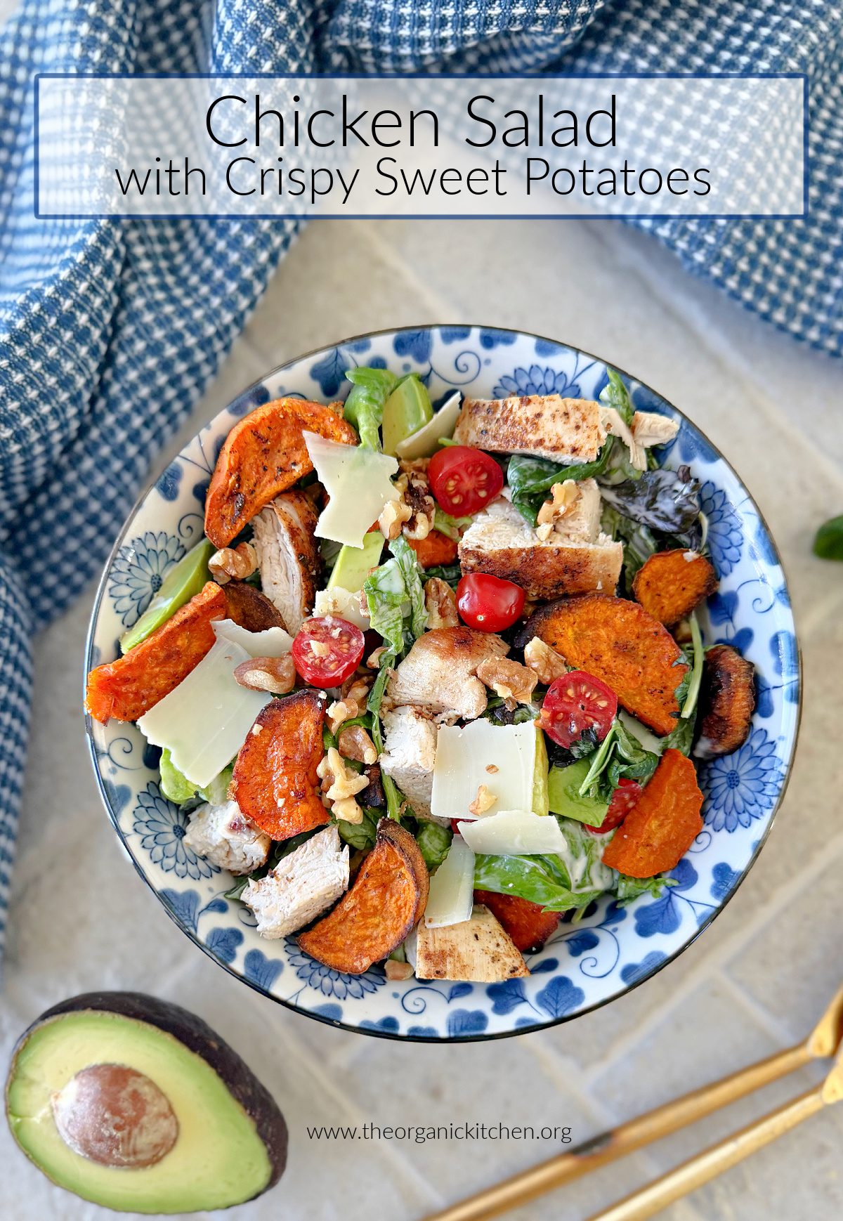 Chicken Salad with Crispy Sweet Potatoes in blue and white bowl with half an avocado and blue and white dish towel in background