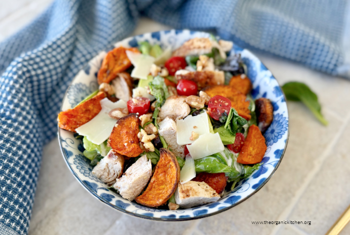 Chicken Salad with Crispy Sweet Potatoes in blue and white bowl with blue dih towel in the background