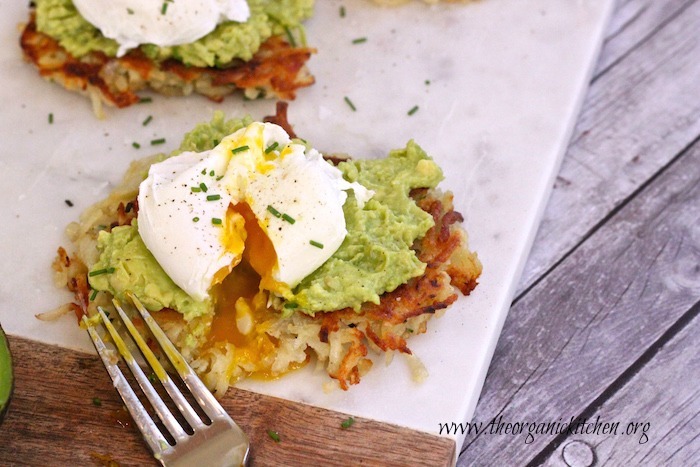 Potato Avocado "Toast" With Perfectly Poached Eggs served on a marble cutting board