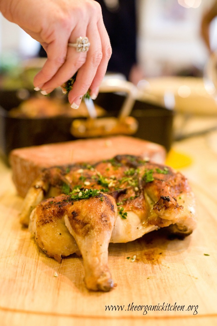 Chicken al Mattone being garnished with parsley