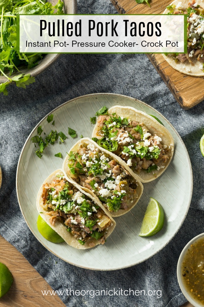Three Pulled Pork Tacos Crock Pot- Instant Pot- Pressure Cooker on a gray plate garnished with lime wedges and cilantro