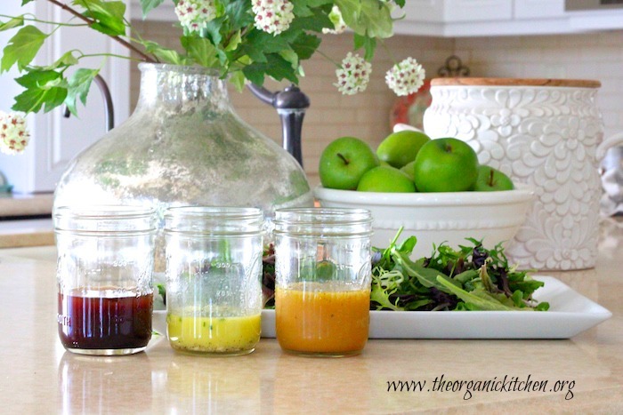 My Favorite Winter Salad Dressings: three mason jars on a kitchen counter filled with salad dressing 