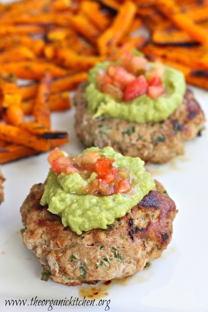  Tow Jalapeño Turkey Burgers topped with guacamole and diced tomatoes served with roasted butternut squash