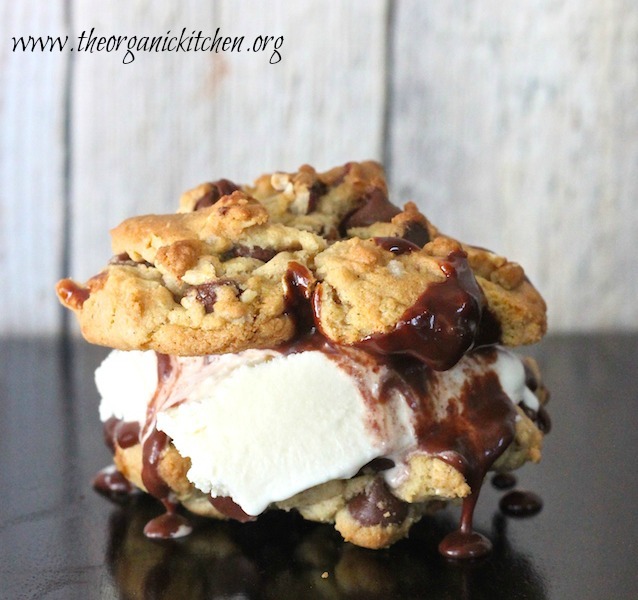 The Chocolate Lover's Ice Cream Sandwich dripping with melted chocolate on wood table