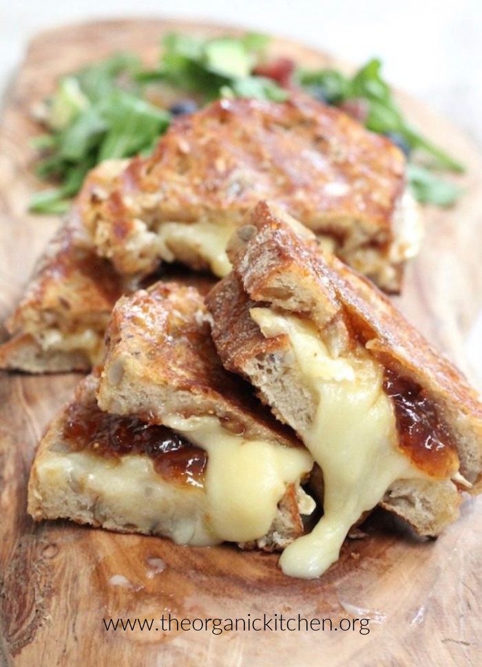 Brie and Fig Grilled Cheese Brie and Fig Grilled Cheese Sandwich on a wood cutting board