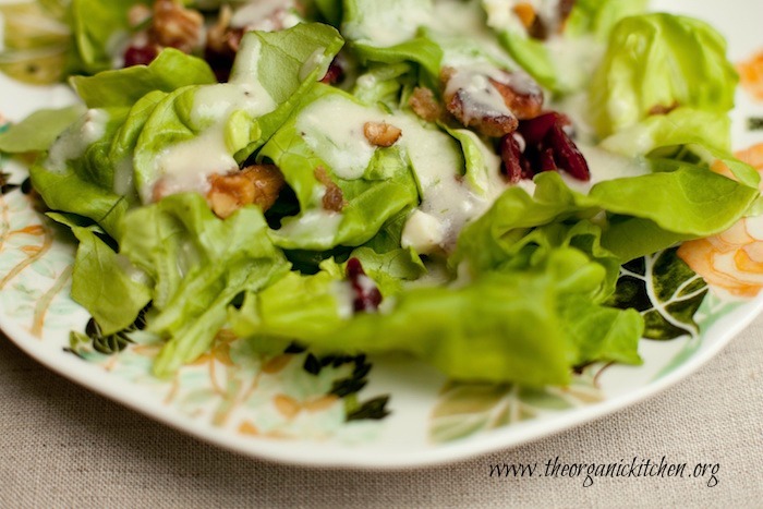 Butter Leaf Salad with Creamy Pear Vinaigrette garnished with caramelized walnuts