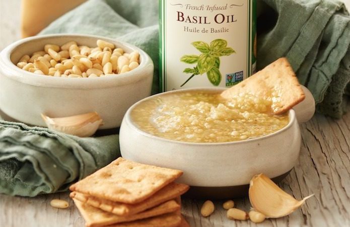 Easy White Basil Pesto A bowl of Easy White Basil Pesto with a cracker in it