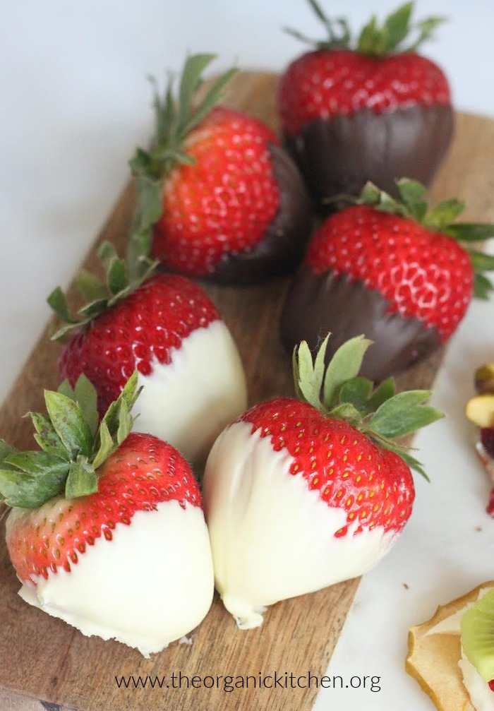 Chocolate dipped strawberries on wooden board as part of this Fruit, Chocolate and Cheese Dessert Platter