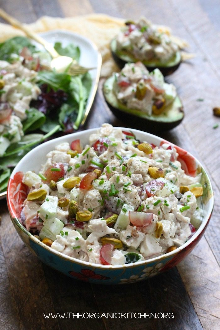 The Best Homemade Chicken Salad in a colorful bowl with two avocados in the background