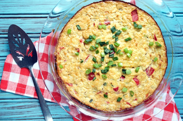 A clear baking dish filled with an egg and bacon casserole, one of 12 Healthy, Delicious (Whole 30) Breakfast Recipes!