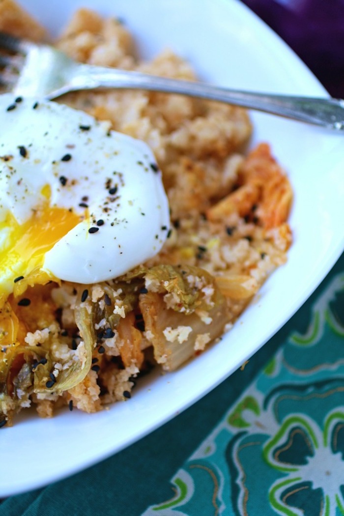 A close up of Kimchi cauliflower rice and poached egg in white bowl, one of 12 Healthy, Delicious (Whole 30) Breakfast Recipes!
