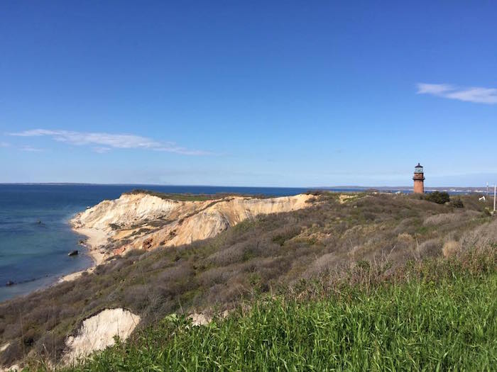 A lighthouse on rocky cliff overlooking the ocean