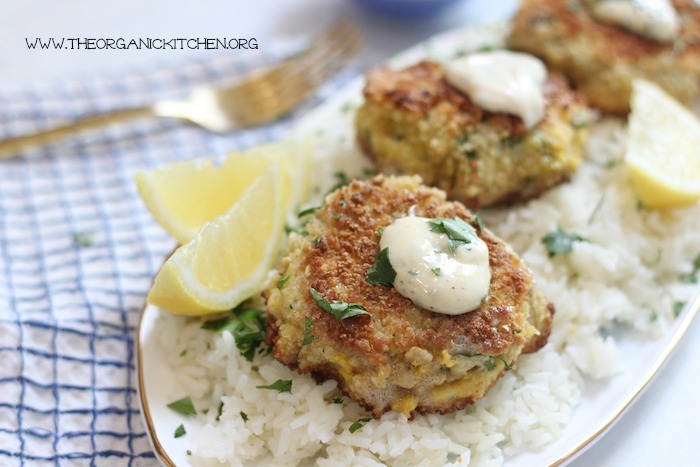 Crisoy Crab Cakes on a bed of rice with gold fork