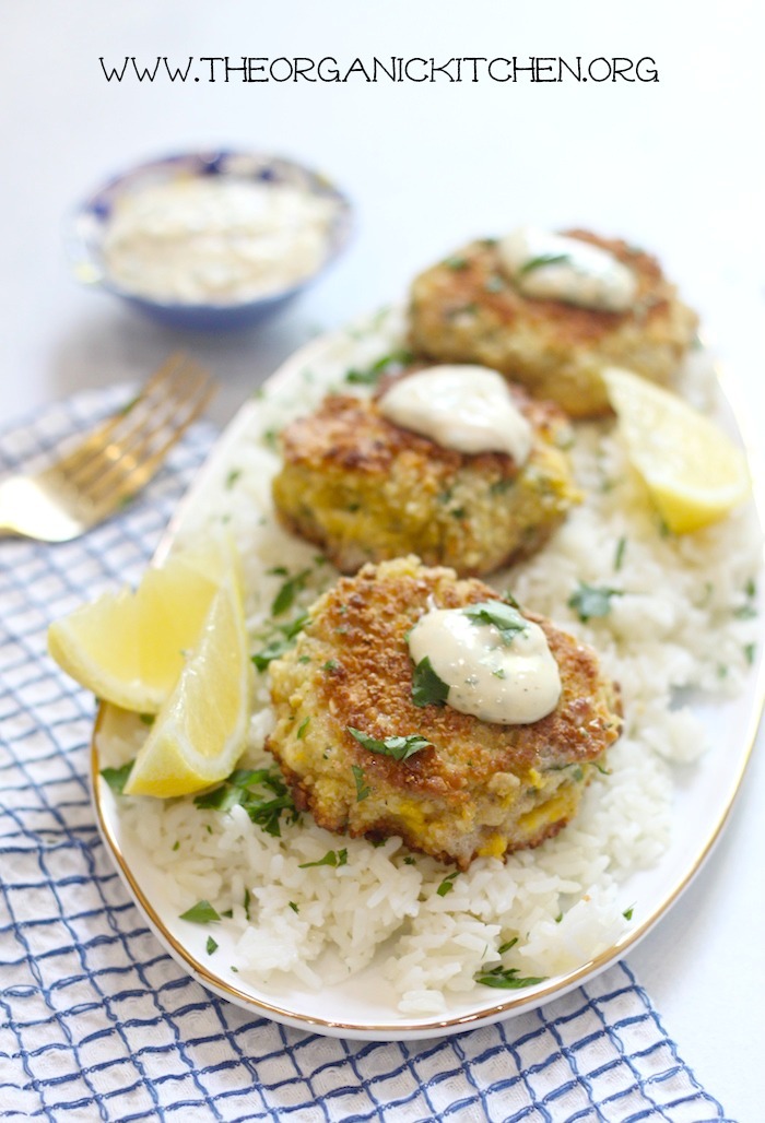 Three crab cakes topped with a dab of aioli 