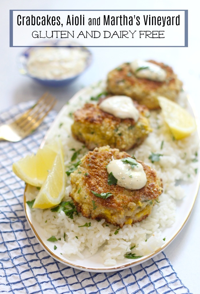 Crab Cakes with Aioli served on a platter on a bed of rice and lemon wedges