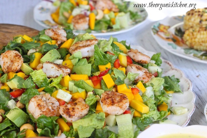 Greens with Grilled Shrimp and Citrus Vinaigrette on white table