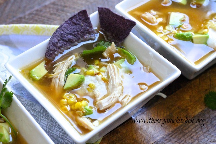 15 Minute Chicken Tortilla Soup with corn and chips in a white bowl.