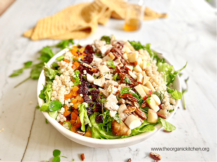 The Harvest Salad: Greens, Couscous, Fall Fruit and Apple Vinaigrette The Harvest Salad: Greens, Couscous, Fall Fruit and Apple Vinaigrette in a white bowl with yellow dish towel in the background