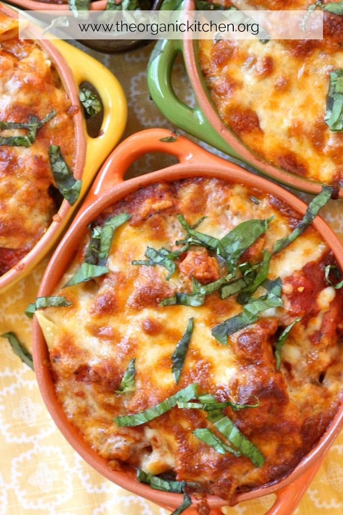 Easy Baked Penne with Italian Sausage garnished with fresh basil