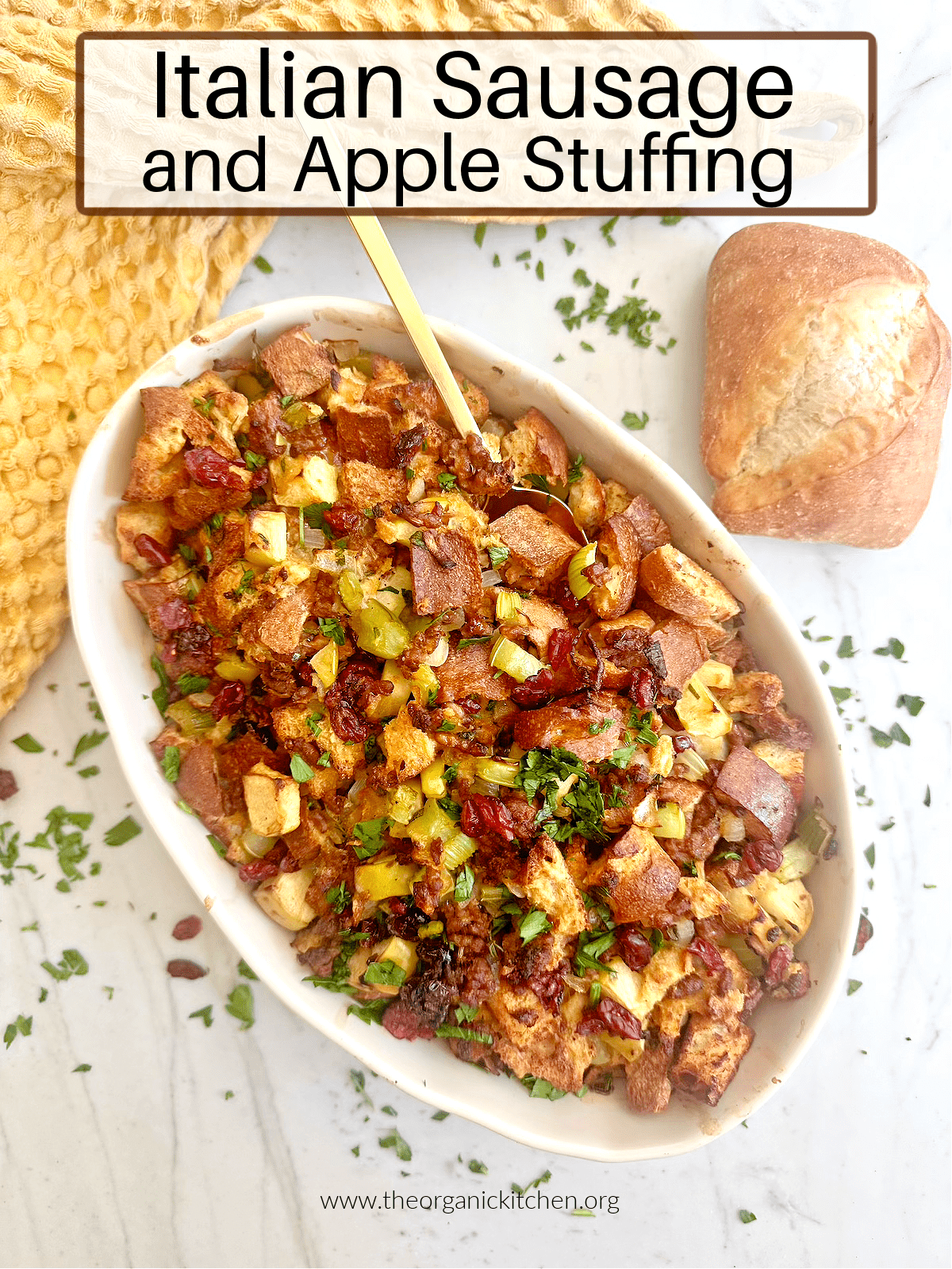 Italian Sausage and Apple Stuffing! Italian Sausage and Apple Stuffing garnished with parsley in white baking disg with a gold spoon