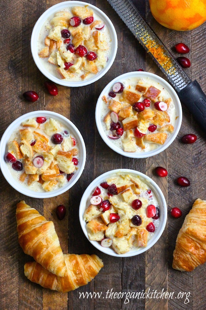 Un cooked Orange Cranberry Bread Pudding: Made with Croissants in white ramekin on wood surface