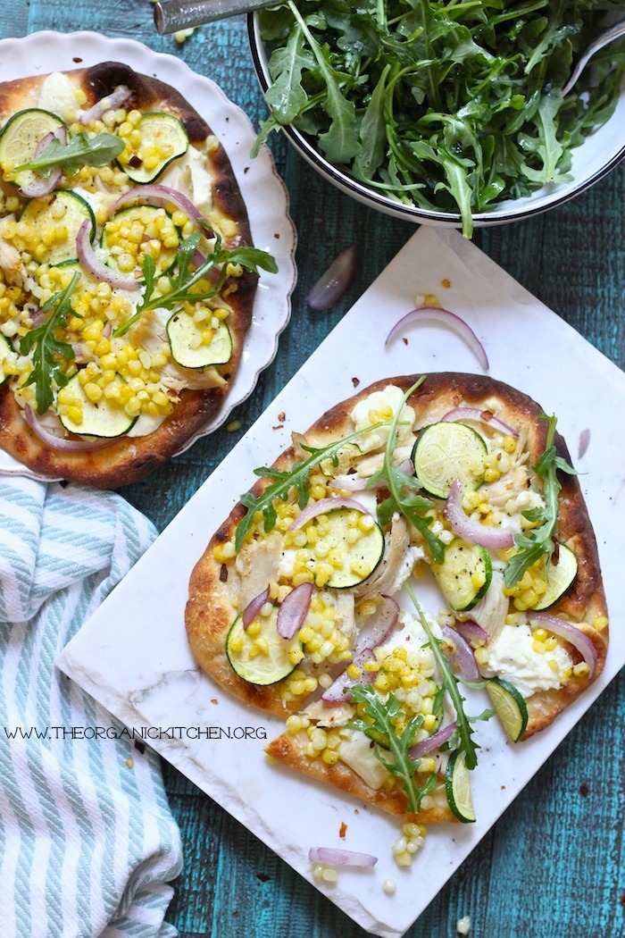 Easy Zucchini & Corn Grilled Naan Pizza garnished with arugula