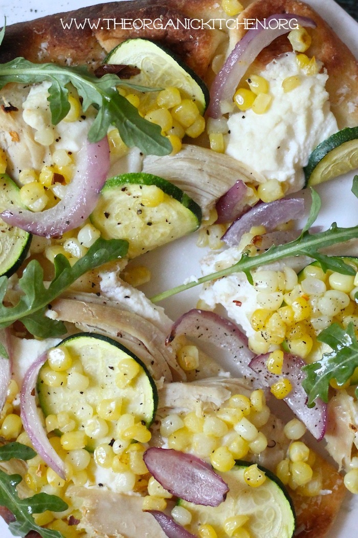 A close up of Easy Zucchini & Corn Grilled Naan Pizza! 