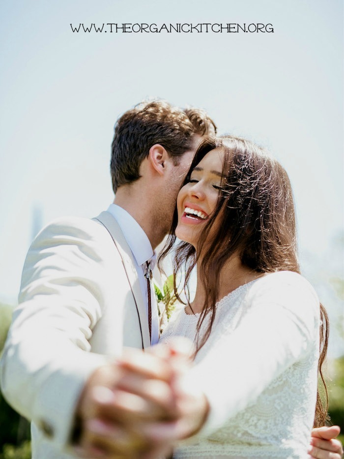 A bride and groom hugging and smiling