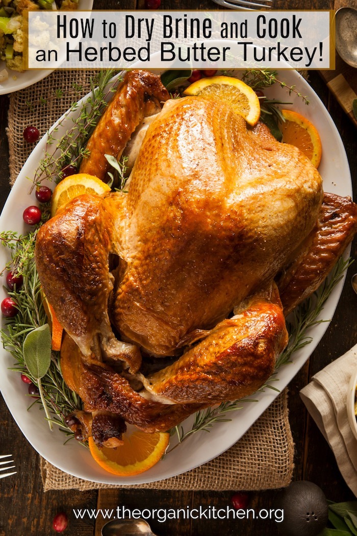 How to Dry Brine and Cook an Herbed Butter Turkey! A golden Turkey on white platter
