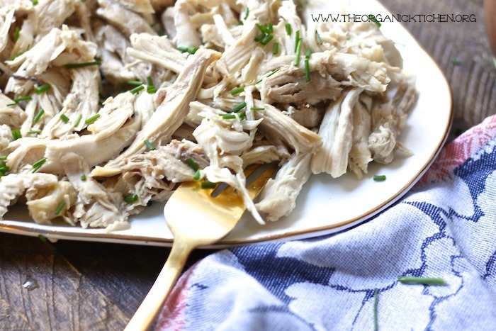 Shredded chicken on platter with gold fork for BBQ Pulled Chicken Sandwiches and Slaw!