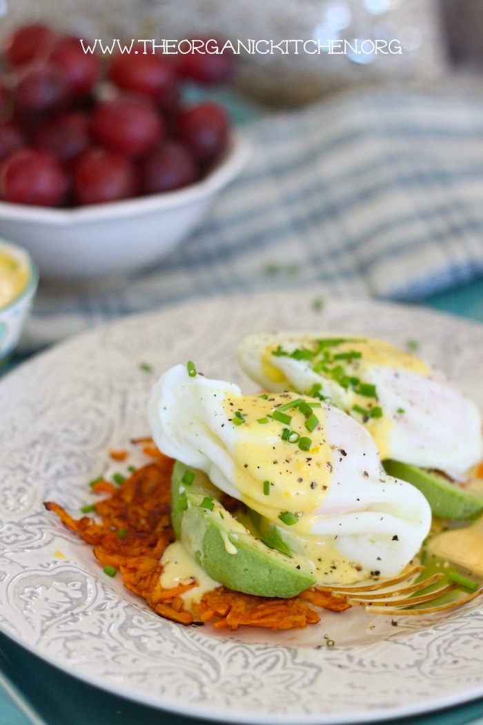A sweet potato fritter topped with avocado, poached eggs and Hollandaise Sauce, one of 12 Healthy, Delicious (Whole 30) Breakfast Recipes!