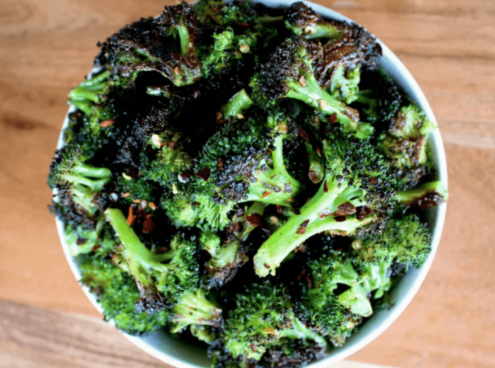 Roasted broccoli in white bowl on wood table: 12 Healthy Whole30 Vegetable Side Dishes! 