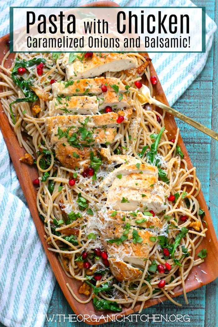 Pasta with Chicken, Caramelized Onions and Balsamic on a wooden platter set on a blue table