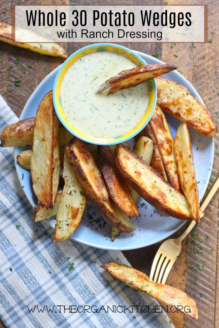 Whole 30 Potato Wedges with Ranch Dressing on a blue plate set on wooden table