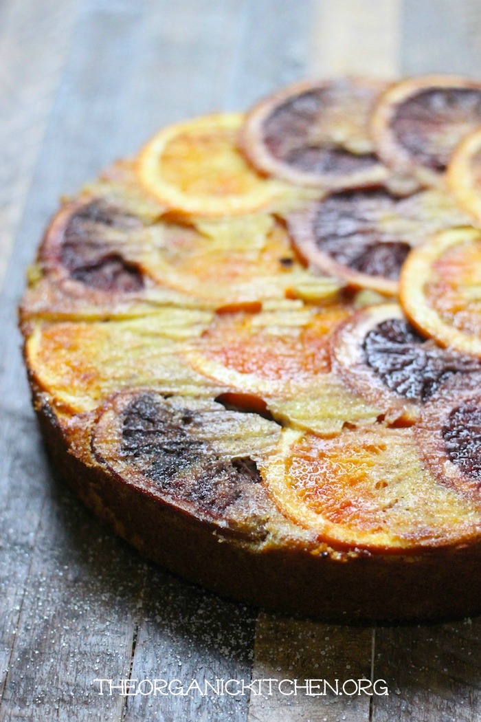 Upside Down Orange Almond Cake made with multi colored blood oranges on a butcher block