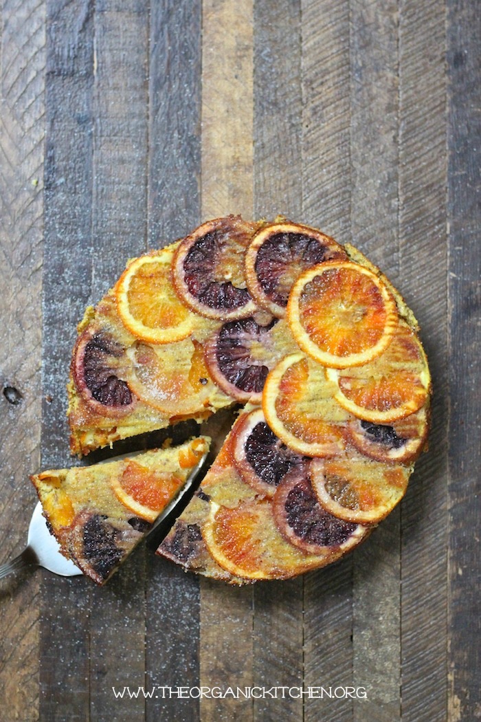 Upside Down Orange Almond Cakewith a slice removed and rresting on a cake server