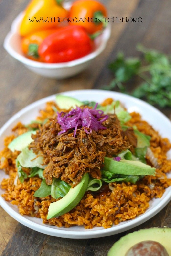 Pulled Pork over Mexican Sweet Potato Rice- Paleo/Whole30 garnished with avocado and purple cabbage on white plate on white plate