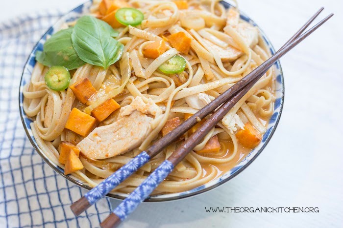 Chicken and Sweet Potato Asian Noodle Soup in blue and white bowl with chop sticks and dish towel