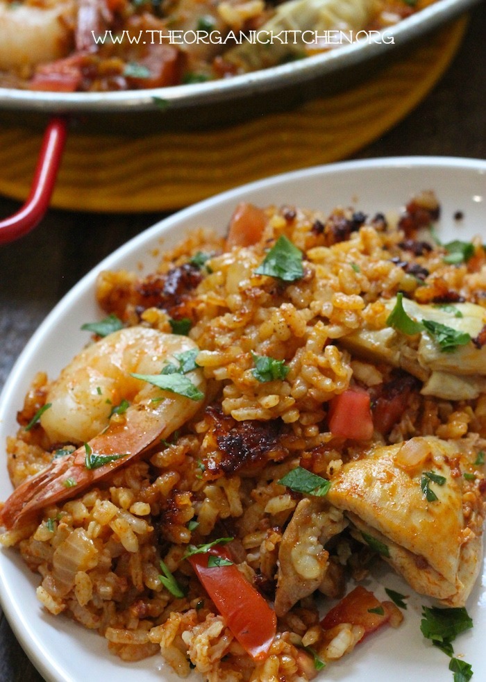 A small plate of Paella Valenciana with Chicken, Chorizo and Shrimp garnished with parsley