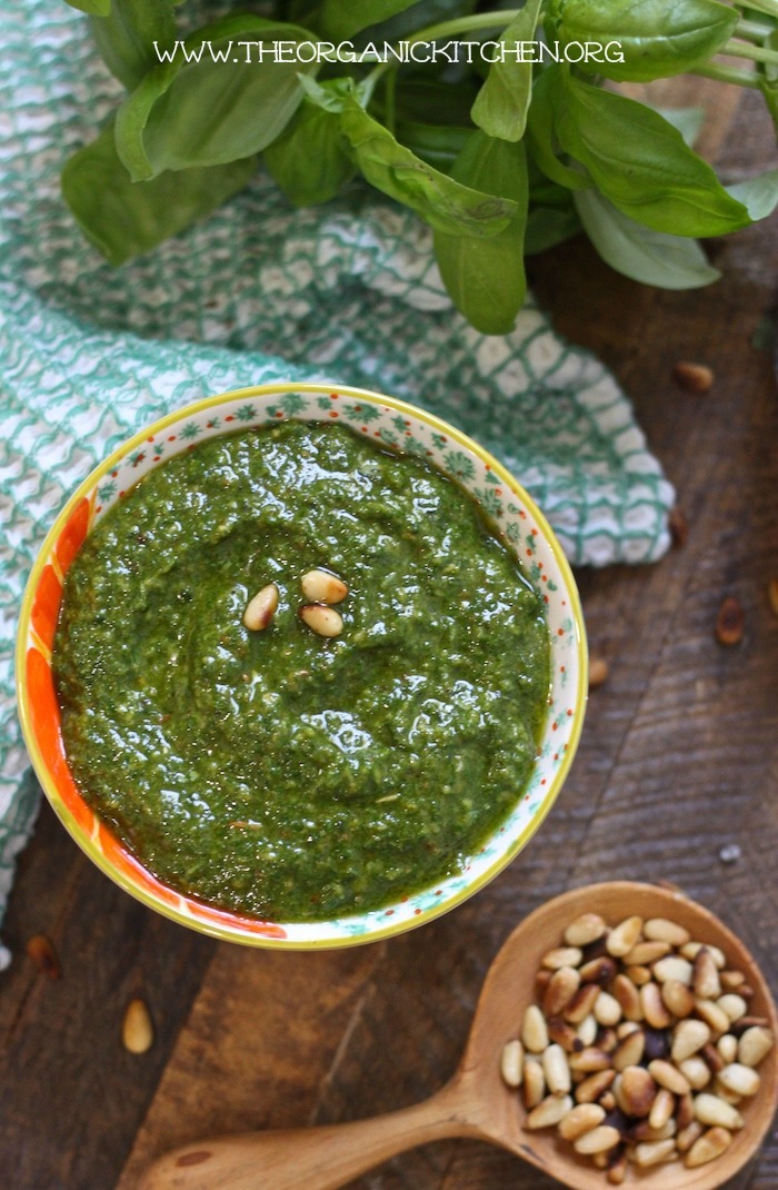 Basil pesto in a small bowl on wood table top as part of 20+ Whole30 Dips, Sauces and Salad Dressings! 