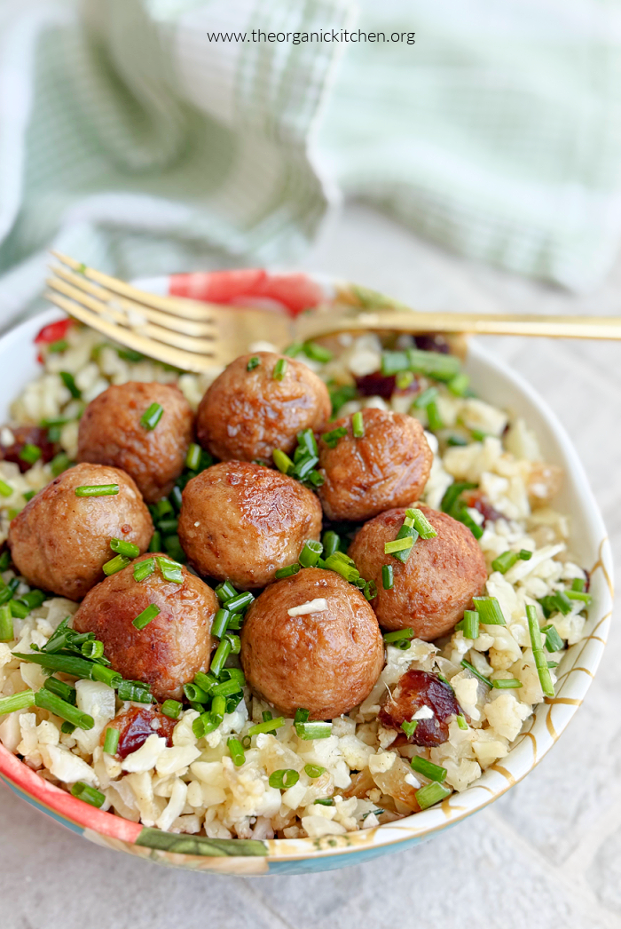 Hungarian Meatballs with Cauliflower “Rice”~ Paleo, Whole30, Keto Hungarian Meatballs with Cauliflower “Rice”~ Paleo, Whole30, Keto garnished with hrbs and gold fork in a colorful bowl