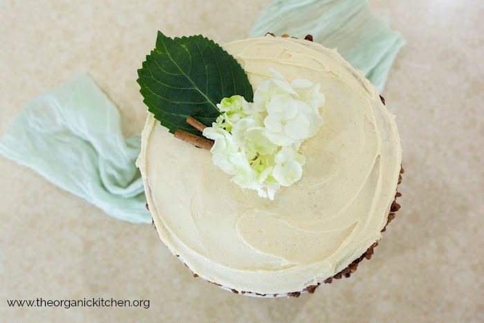 French Cream Cake with Maple Cream Cheese Frosting and Cinnamon Pecans decorated with flowers and cinnamon sticks